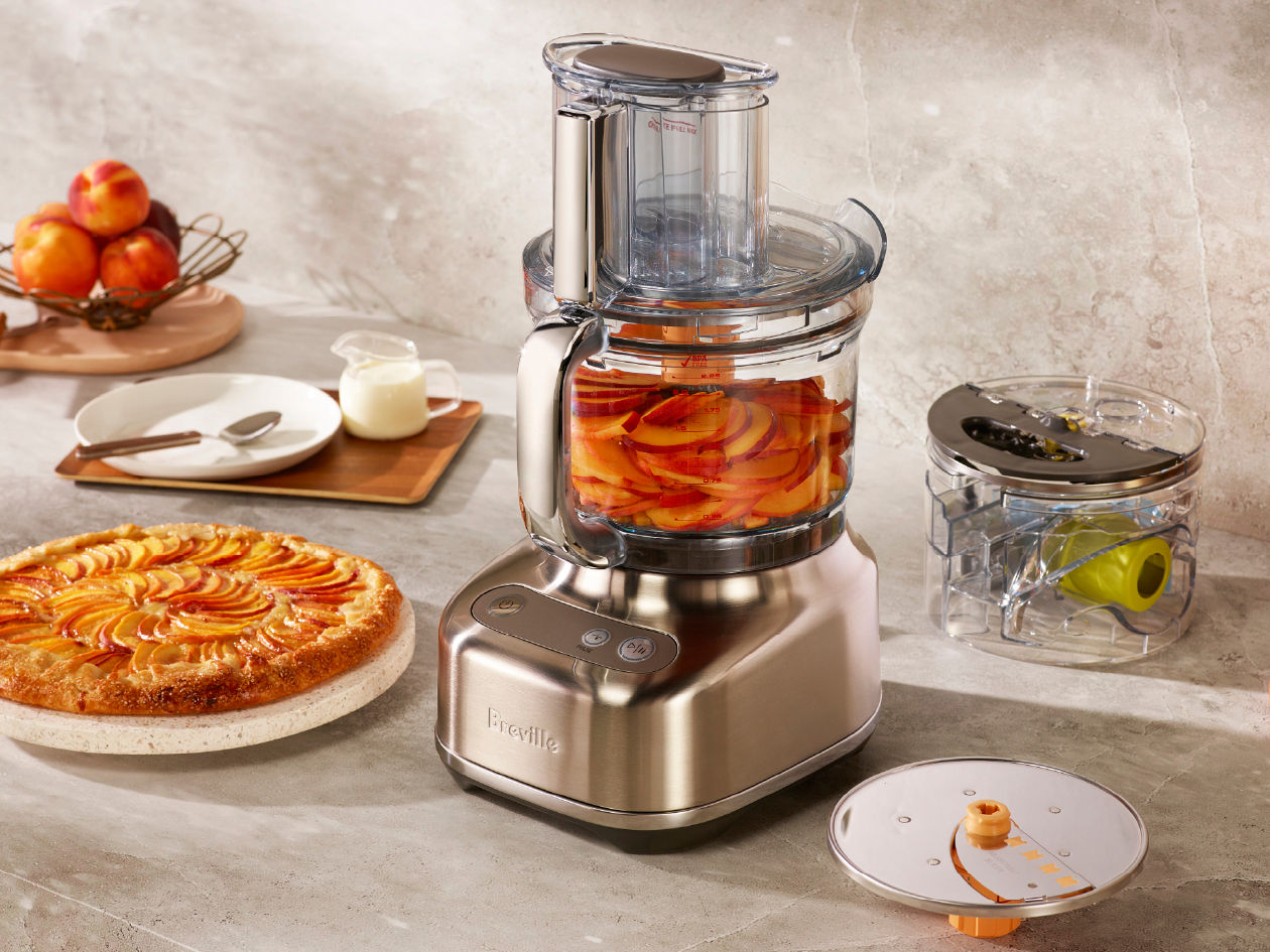 Breville Kitchen Wizz 12 cup food processor preparing a large batch meal on a kitchen bench.