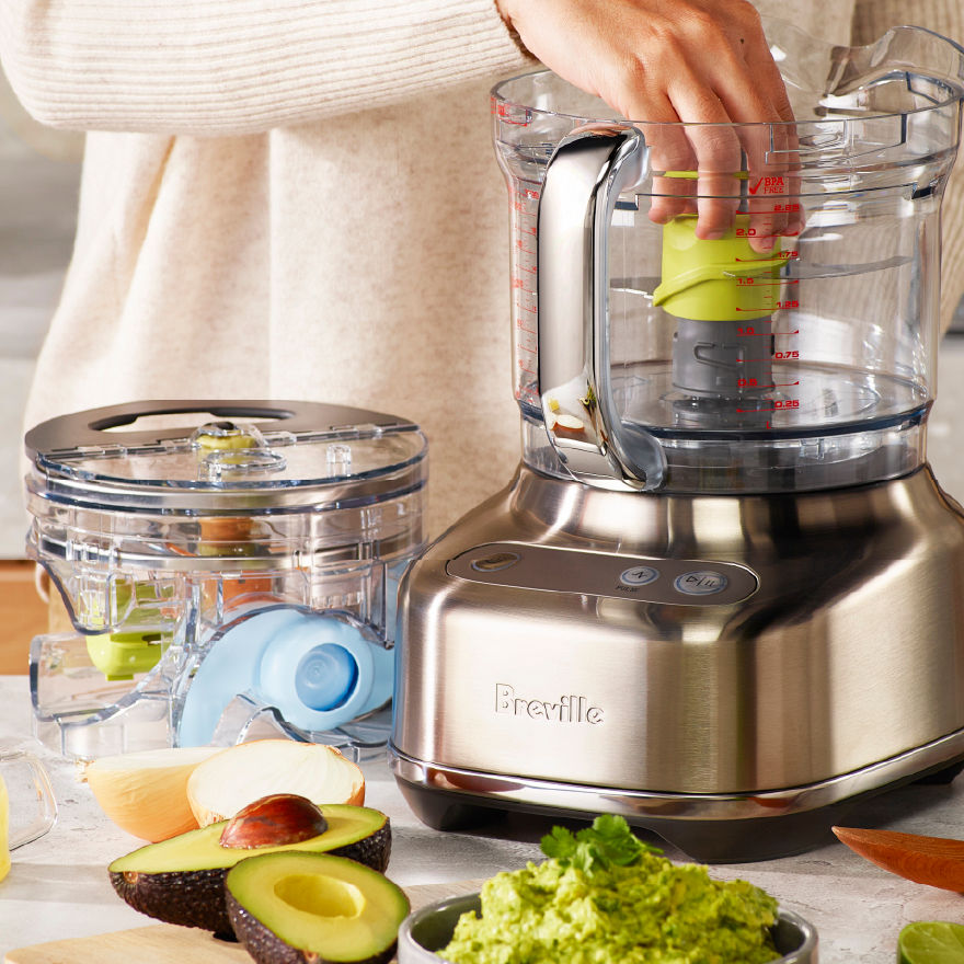 Breville food processor colour-coded accessories displayed alongside the food processor, showing the Chef's Armory storage system.