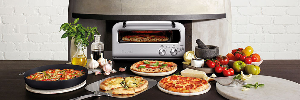 The Pizzaiolo on countertop with various pizzas