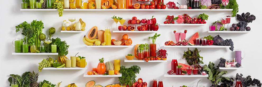 Shelves of various juices and fruits