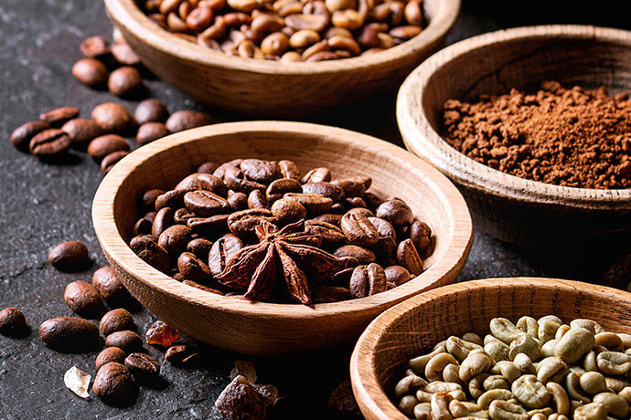 Various different types of coffee beans in bowls