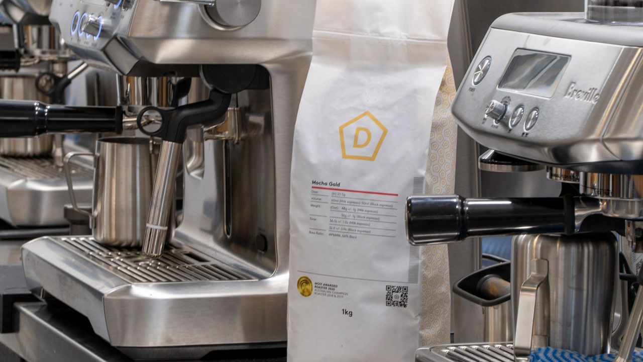 Danes coffee specialist at a cupping session informing audience.