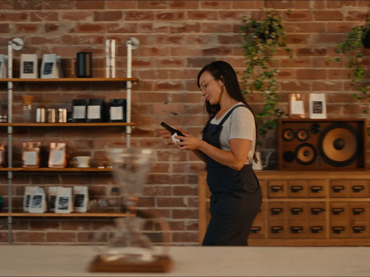 Video showing a coffee tasting process, coffee bean bags on display, and a person evaluating coffee aroma and flavour