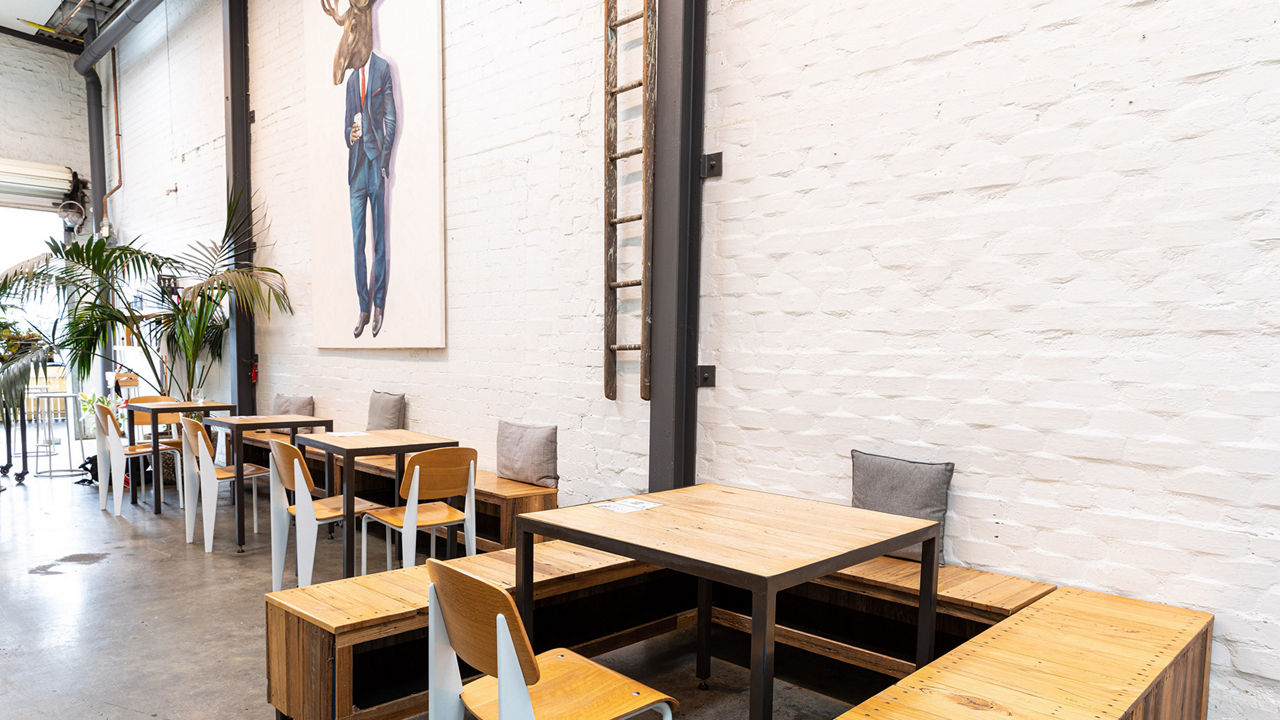 Maker cafe location with merch in background.