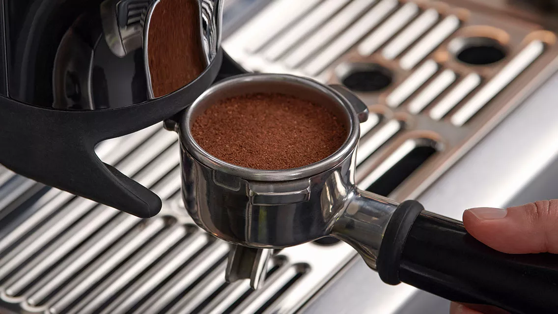 A portafilter full of coffee.