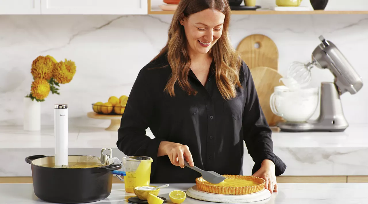 Woman looking down at pie next to the Joule Turbo Sous Vide