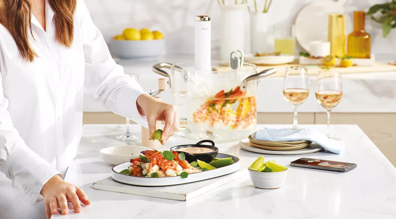 Woman squeezing lime on a seafood dish