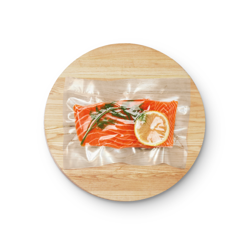 Salmon fillet and garnishment in a bag
