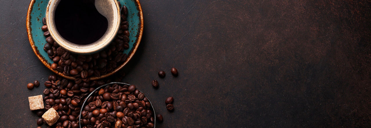 Black coffee with beans surrounding
