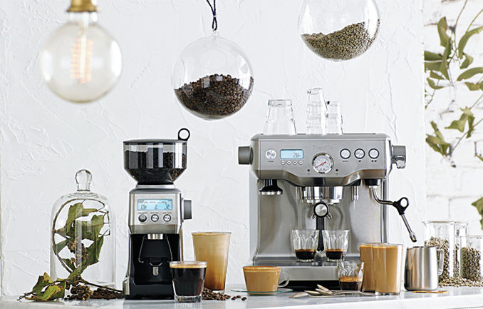 the Smart Grinder Pro and the Oracle with accessories on bench 