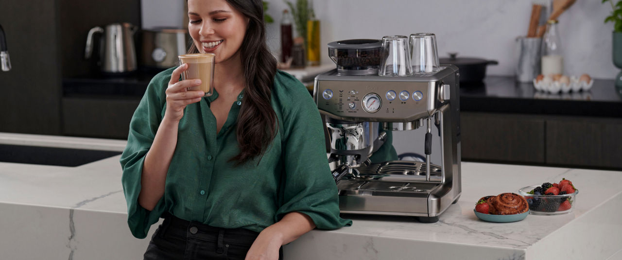 woman with coffee and sage espresso machine