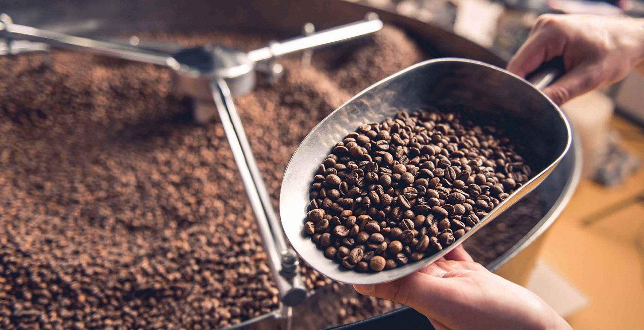 Darkly roasted beans in a scoop